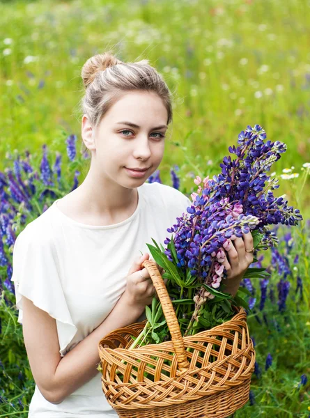 Flicka med blombukett Lupin — Stockfoto