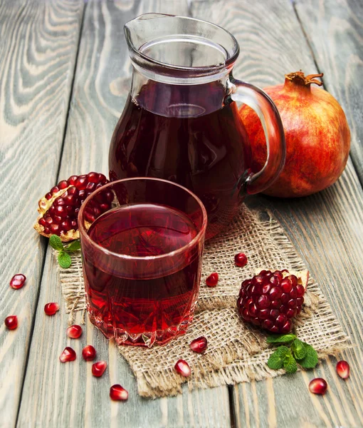 Pitcher and glass of pomegranate juice — Stock Photo, Image