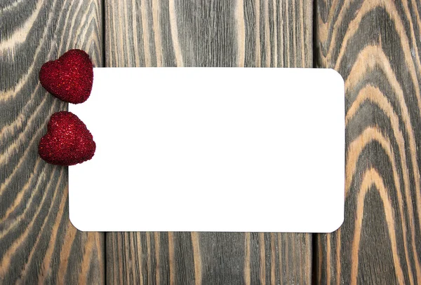 Dois corações e cartão de saudação — Fotografia de Stock