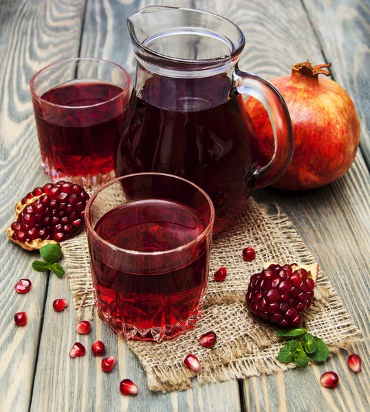 Pitcher and Two glasses of pomegranate juice — Stock Photo, Image