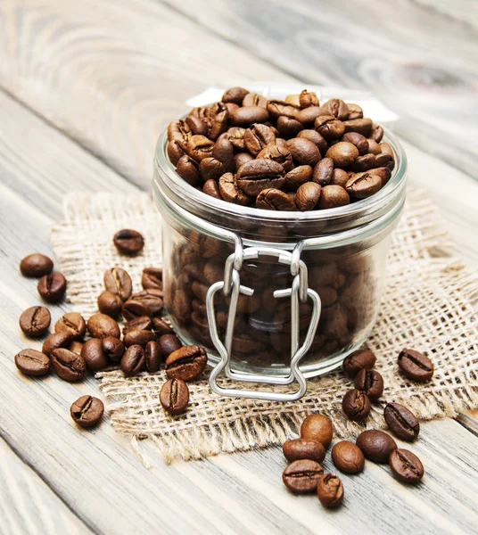 Glass jar full of coffee beans — Stock Photo, Image