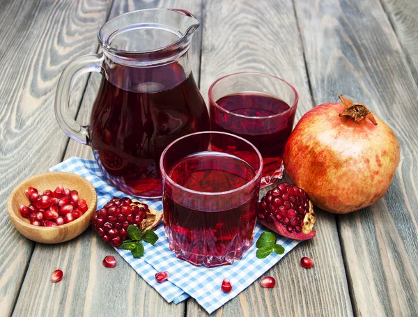 Pitcher and Two glasses of pomegranate juice — Stock Photo, Image