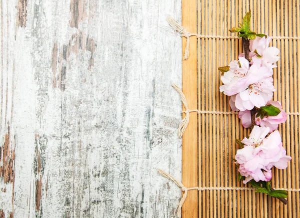 Sakura branch on a bamboo mat — Stock Photo, Image