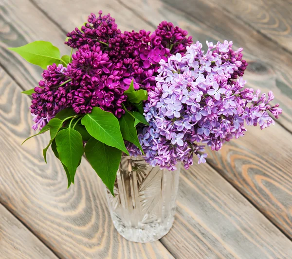 Vase with lilac flowers — Stock Photo, Image