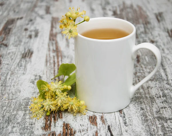 Cup of herbal tea with linden flowers — Stock Photo, Image