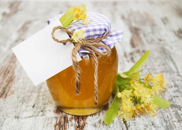Jar of honey and linden flowers — Stock Photo, Image