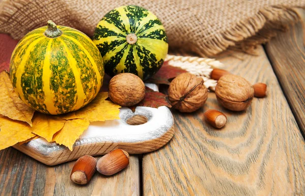 Autumn pumpkins and nuts — Stock Photo, Image