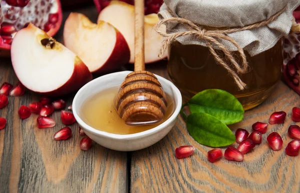Honey with pomegranate and apples — Stock Photo, Image