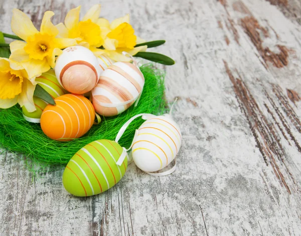 Easter eggs in a nest with flowers — Stock Photo, Image