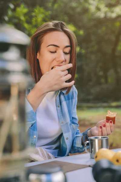 Mulher comendo bolo no café da manhã na floresta — Fotografia de Stock