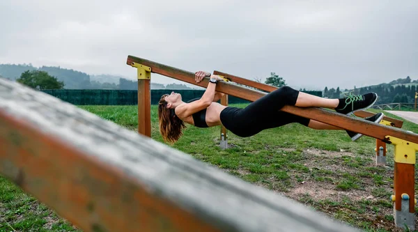 Trening sportowców wiszący na drewnianym barze — Zdjęcie stockowe