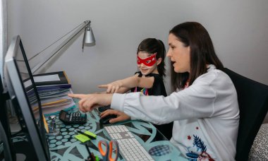 Kızıyla telgraf çeken bir kadın ona bir resim gösteriyor.