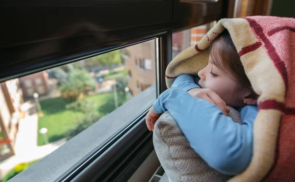 Sad girl looking out the window — Stock Photo, Image