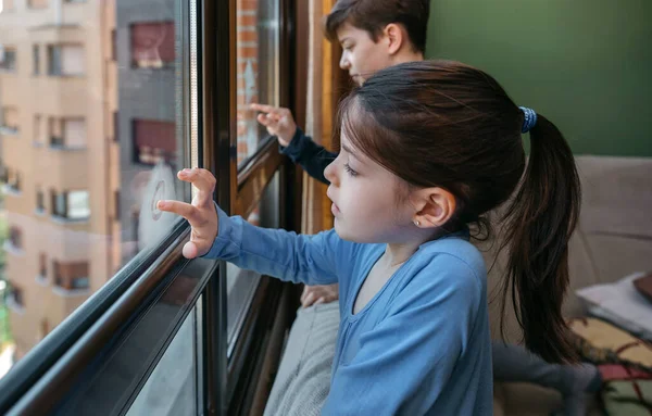 Dvě děti v koronavirové uzamykatelné kresbě na okně — Stock fotografie