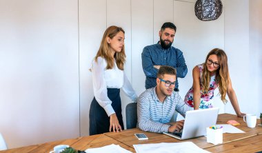 Business people in a meeting standing checking a project