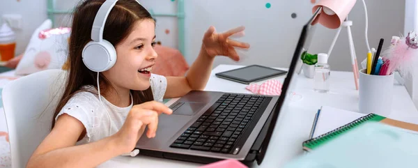 Девочка учится на дому с ноутбуком — стоковое фото