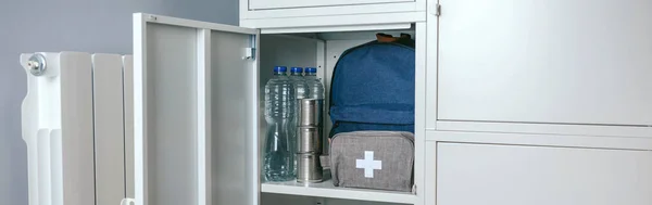 Rugzak en EHBO-doos in een kast. — Stockfoto