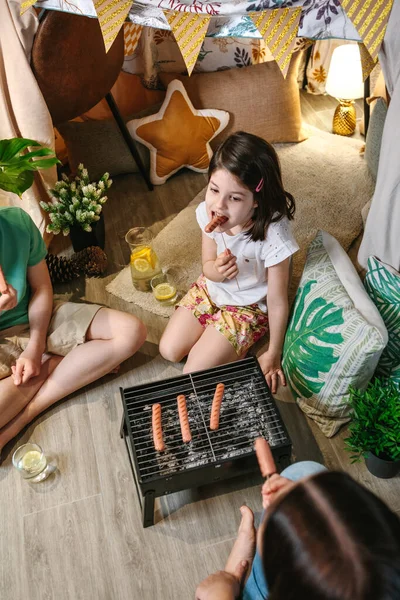 Vista superior de la chica comiendo salchicha con su familia —  Fotos de Stock