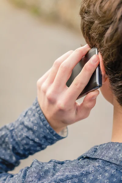 Hipster adolescente falando com um telefone inteligente ao ar livre — Fotografia de Stock