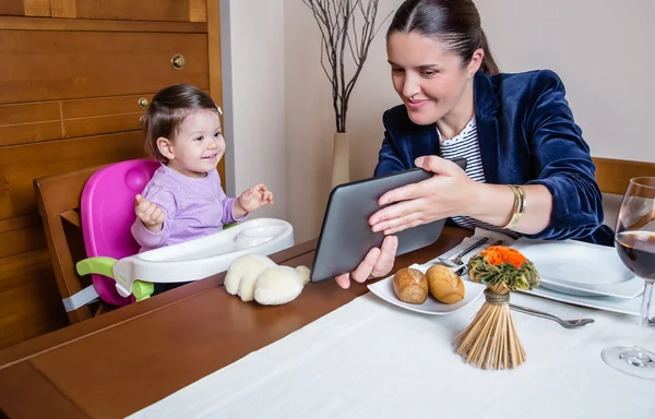 Businesswoman mother and baby girl looking tablet — Stock Photo, Image