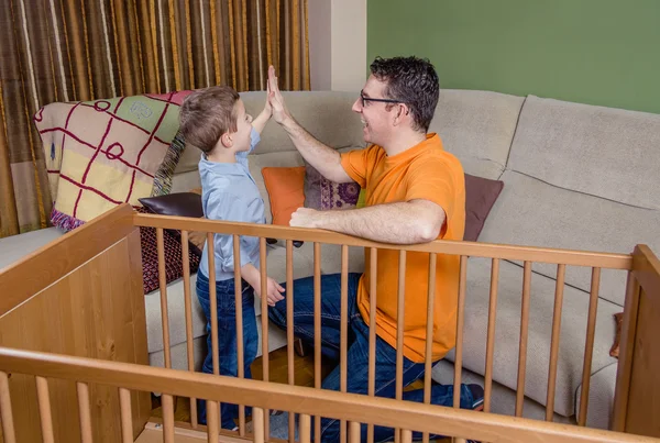 Pai e filho dando cinco para o sucesso em um trabalho em casa — Fotografia de Stock