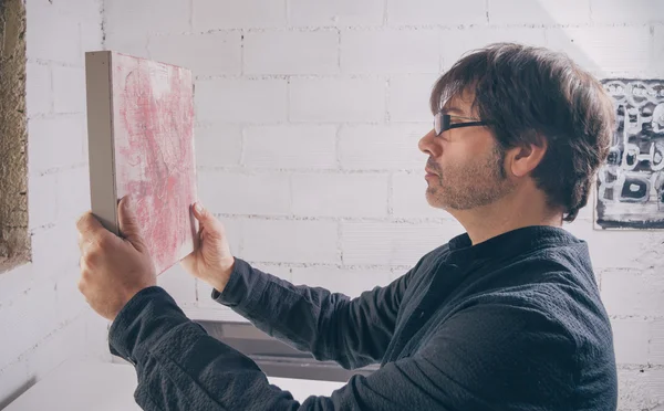 Painter artist looking his finished modern artwork — Stock Photo, Image