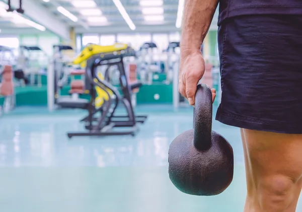 Man holding kettlebell in a crossfit training — Stock Photo, Image