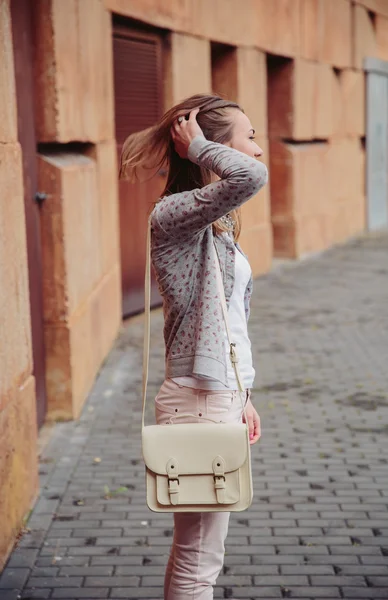 Jovem mulher da moda tocando seu cabelo ao ar livre — Fotografia de Stock