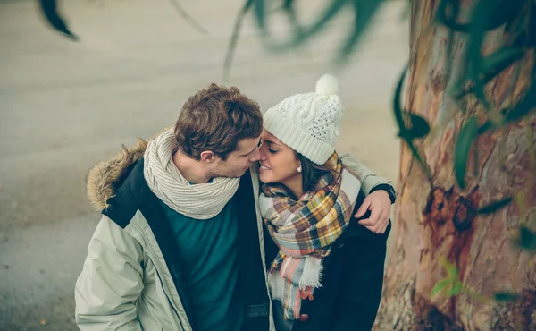 Young couple in love embracing and kissing outdoors — Stock Photo, Image