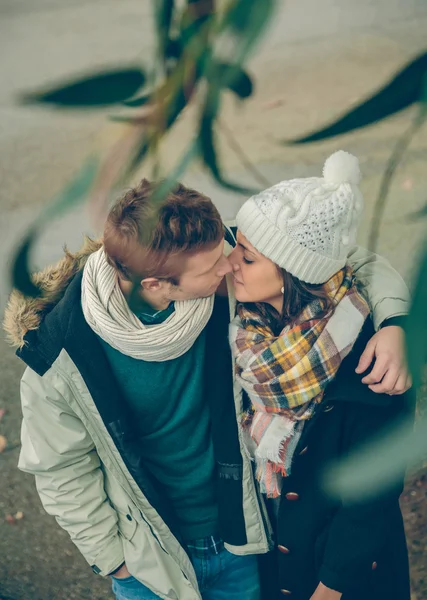 Young couple in love embracing and kissing outdoors — Stock Photo, Image