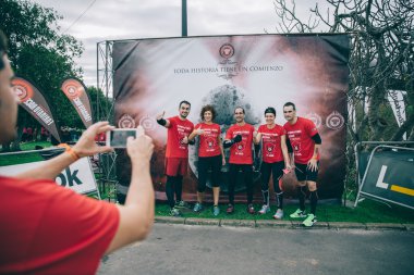 Runners team posing in front of official banner before the race