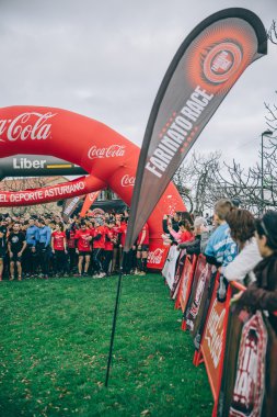 Runners in a extreme obstacle race on start line ready to run