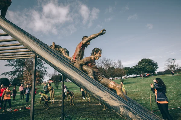 Runners going down structure in a test of extreme obstacle race — Stock Photo, Image