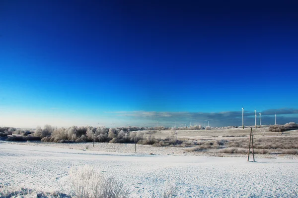Beautiful cold winter landscape with wind generators on background — Stock Photo, Image