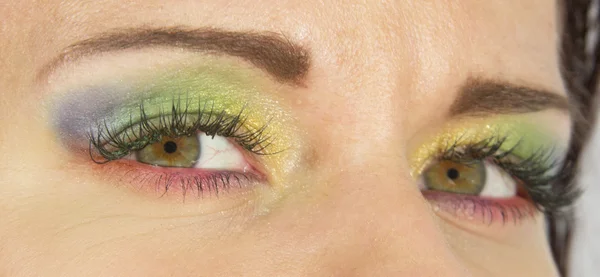 Eyes colored as beautiful rainbow. Hippy fashionable makeup style.