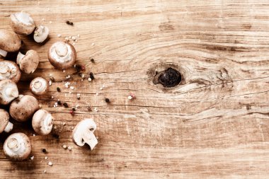 fresh mushrooms on old wooden table