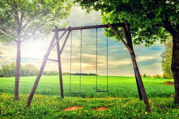 Lonely swing at summer sunset — Stock Photo, Image