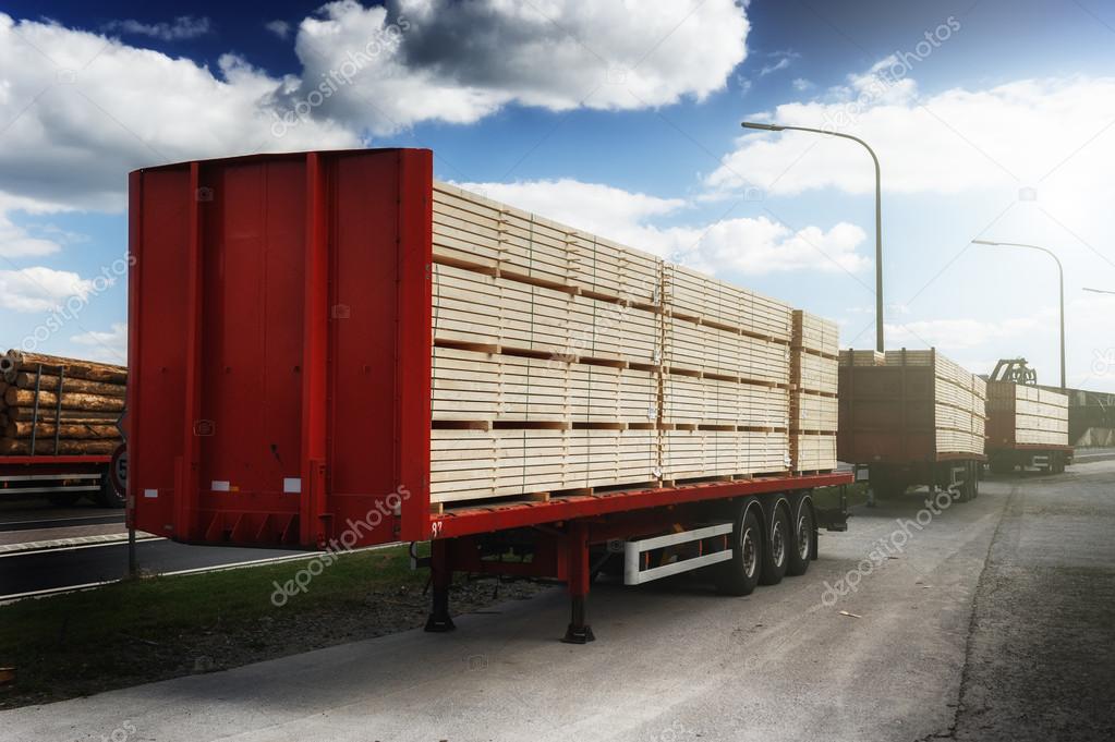 Trucks charged with wood planks