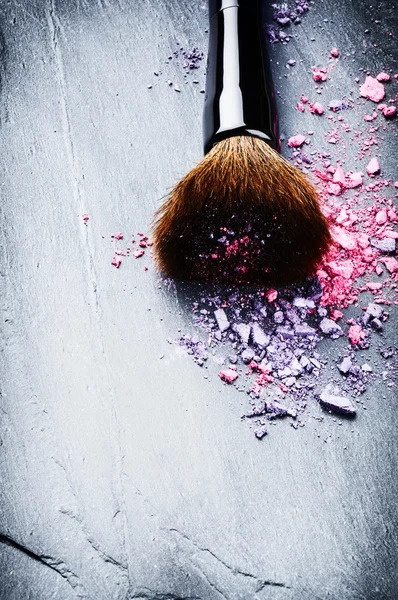 Makeup brush and crushed eye shadows — Stock Photo, Image