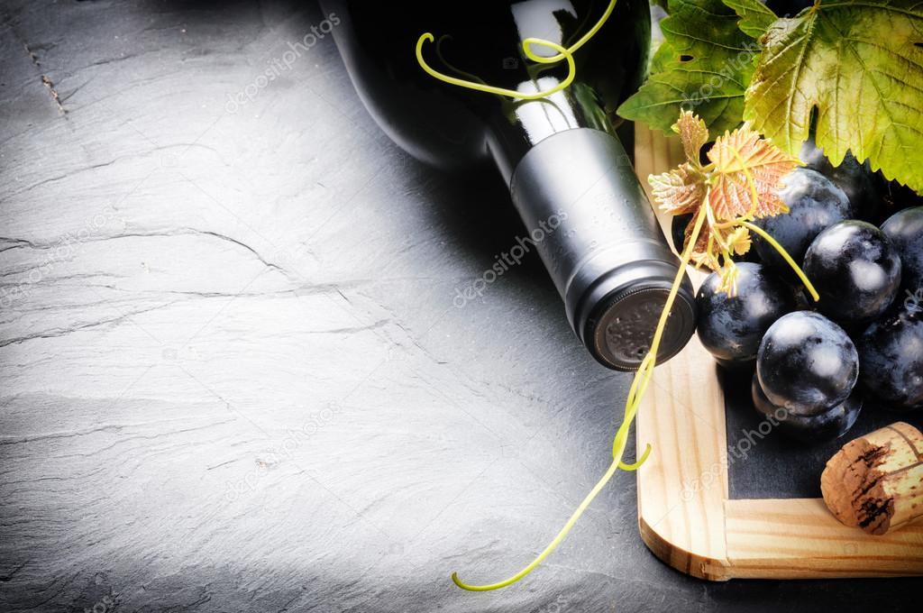 Frame with wine bottle and fresh grape