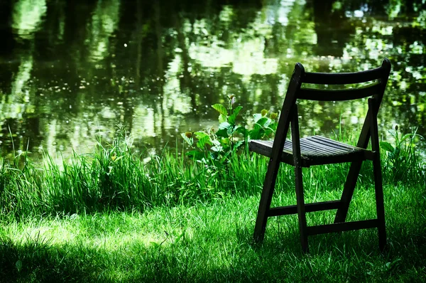 Lonely old chair in garden — Stock Photo, Image
