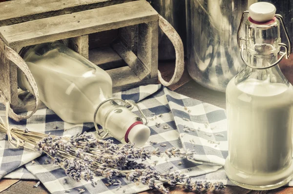 Rustic setting with fresh milk bottles — Stock Photo, Image