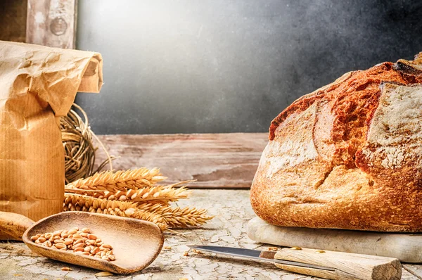 Baked bread in rustic setting — Stock Photo, Image
