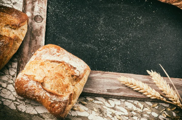 Rustic frame with bread and wheat — Stock Photo, Image