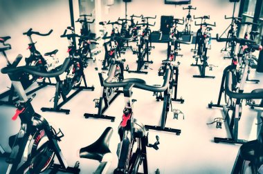 Spinning class with empty bikes clipart