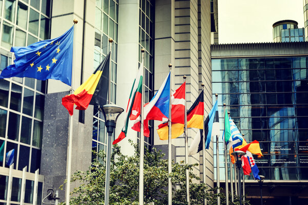 Waving flags in front of European Parliament