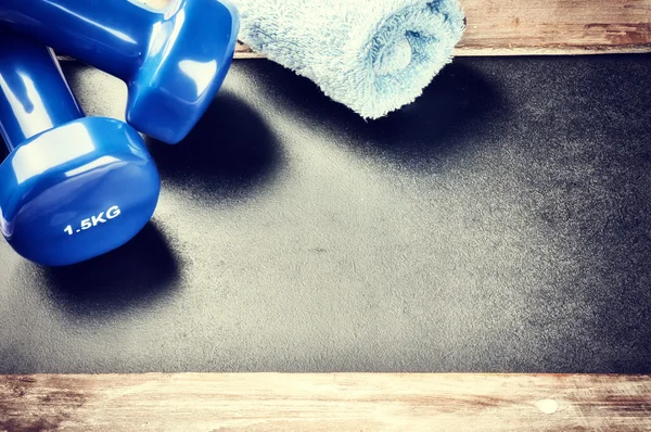 Fitness frame with dumbbells and towel — Stock Photo, Image