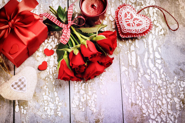 red roses with decorative hearts and presents