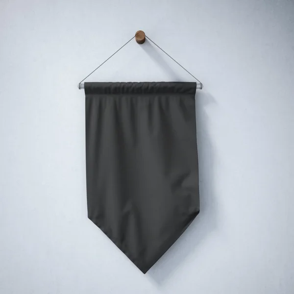 Black pennant hanging on a concrete wall — Stock Photo, Image