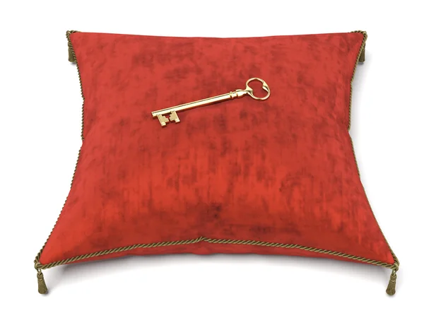 Червона оксамитова подушка і ключ — стокове фото
